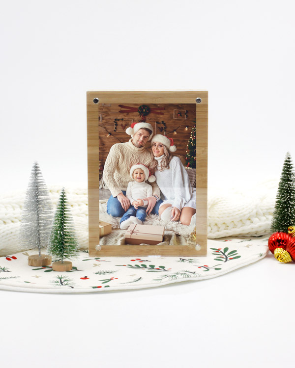 A festive family photo displayed in an acrylic and bamboo frame